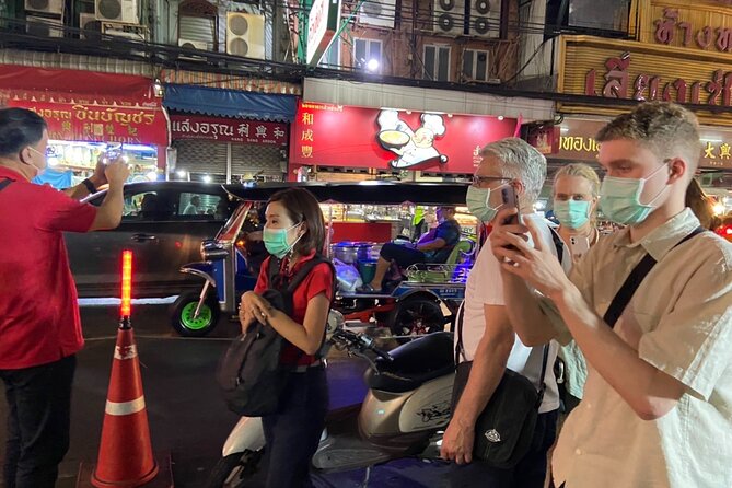Bangkok: Michelin Guide Street Food Tour by Tuk Tuk - Walking Yaowarat Road after dark