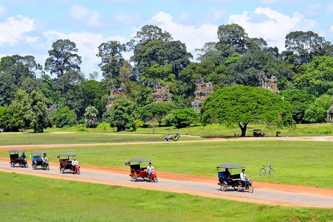 The Angkor Temples from Sunrise by Tuk Tuk - Bayon Temple and its stone faces